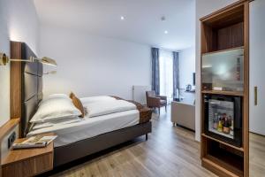 Postel nebo postele na pokoji v ubytování IMLAUER Hotel Nestroy Wien