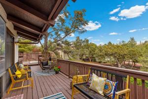 a patio with chairs and a table on a deck at Large Spanish Villa -Hot tub- Pool -Gym- Game Room in Sedona
