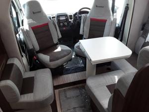 a van with seats and a table in the back at Zebra motorhome hire in Ravensworth