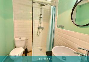 a bathroom with a shower and a toilet and a sink at Colibri Studio Coeur de Ville Mon Groom in Troyes