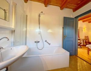 a bathroom with a tub and a sink at Haus-Wolfram-App-Wilhelmine in Morsum