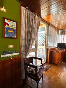 a living room with a chair and a window at Casa Lunastella Locazione Turistica in Mondello