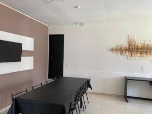 einen Konferenzraum mit einem schwarzen Tisch und Stühlen in der Unterkunft Casa Villa Carlos Paz, a 3 cuadras del río. Playas de Oro in Villa Carlos Paz