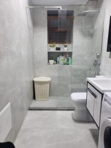 uma casa de banho branca com um WC e um lavatório em Tuana's Apartment em Shkodër