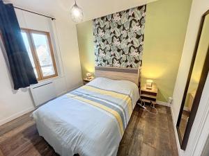 a small bedroom with a bed and a window at Appartement à 30 m de la plage - balcon - proche Centre - WIFI -Le Cérès 3 in Berck-sur-Mer