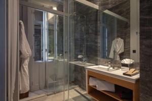 a bathroom with a glass shower and a sink at Boutique Hotel Cordial Malteses in Las Palmas de Gran Canaria