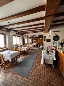 a restaurant with white tables and chairs in a room at Wohnungen bei Post in Hünfelden