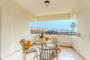 a balcony with a table and chairs with a view at OBSIDIAN Apartamento Santa María in Adeje