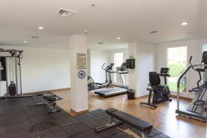 a gym with several treadmills and exercise bikes at A Star Oasis Condo in Palm-Eagle Beach