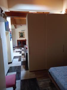 a bedroom with a closet and a living room at Ca' d Licio in Polinago