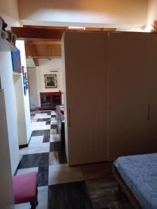a bedroom with a closet and a living room at Ca' d Licio - Attico in Polinago
