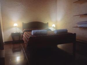 a bedroom with a bed with two lamps on it at cabañas elita in San Rafael