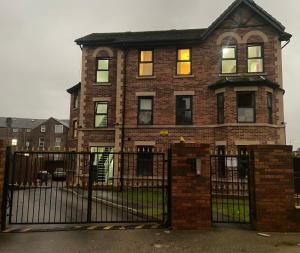 une maison en briques avec un portail en face de celle-ci dans l'établissement Lovely 3 Dbl Bed (sleeps upto 6) close to centre., à Manchester