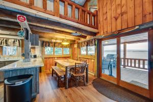 a dining room with a table and chairs in a cabin at Pittsburg Lake House with Magalloway Mountain Views! in Pittsburg
