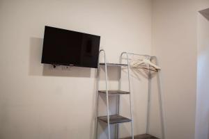 a flat screen tv hanging on a wall at La stanza del Mazzini 3P NO ascensore NO cucina in Pavia