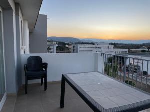 a balcony with a table and a chair on a building at Apartamento ático en Denia in Denia