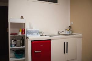 a kitchen with a red and white counter top at La Stanza di Cavour 2 piano NO ascensore in Pavia