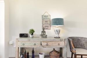 an old wooden table with a lamp and a chair at Mijas Golf in Santa Fe de los Boliches