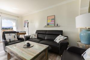 a living room with a couch and a table at Mijas Golf in Santa Fe de los Boliches