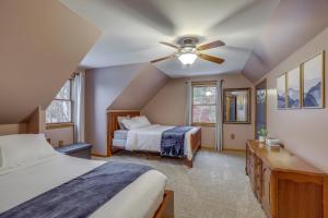 a bedroom with two beds and a ceiling fan at Lovely Interlaken Home with Pool, Fire Pit and Yard! in Interlaken