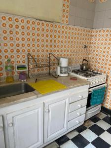 a kitchen with a sink and a stove at La Mitre in Santiago del Estero