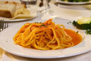 a white plate of spaghetti on a table at Hotel Portonuovo in Vieste
