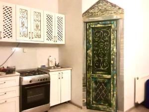 a kitchen with an ornate door in a room at Batumi Wonderland Guest House in Batumi