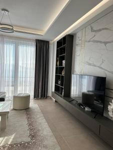 a living room with a large flat screen tv at Sea View Apartment Luxury in Vlorë