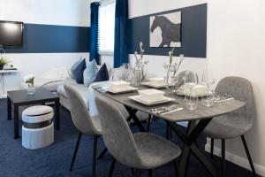 - une salle à manger avec une table, des chaises et un canapé dans l'établissement Modern 4 bedroom Burnham Slough, à Burnham