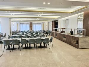 a conference room with a long table and chairs at BRIGHT TOWER HOTEL in Bethlehem +28 photos