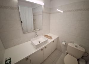 a white bathroom with a sink and a toilet at Cozy 2 Bdr Nicosia City Free Parking Wifi in Nicosia