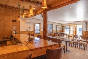 a dining room with a large wooden table and chairs at HOTEL NOMADES PATAGONIA in Coihaique