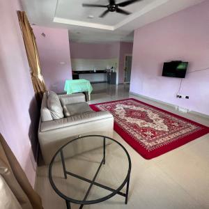 a living room with a couch and a table at D` Totok HouseStay in Sepang