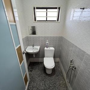 ein Bad mit einem WC und einem Waschbecken in der Unterkunft D` Totok HouseStay in Sepang