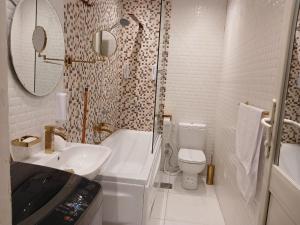 a bathroom with a sink and a toilet and a shower at Midtown Nile View Suites in Cairo +34 photos