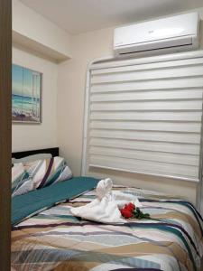 Un dormitorio con una cama con una toalla. en The CUPID: Comfortable living by Awsom Phil, en Manila