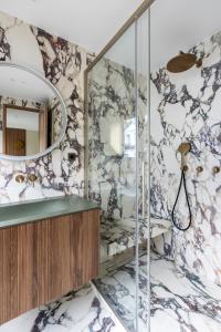 a bathroom with a shower with a mirror at HIGHSTAY - Luxury Serviced Apartments - Centre Pompidou in Paris