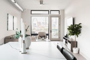 a living room with a table with plants on it at City Views! - Chic Jefferson Park Condo - Tesoro in Denver