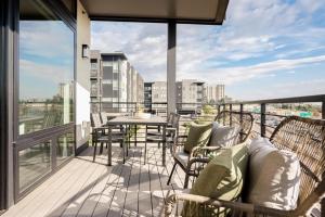 a balcony with a table and chairs on a building at City Views! - Chic Jefferson Park Condo - Tesoro in Denver