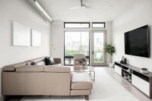 a living room with a couch and a tv at Contemporary Condo - Grill - Balcony - Tesoro in Denver