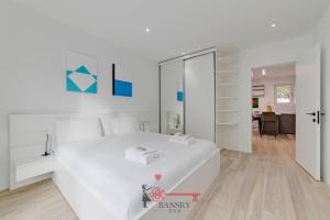 a white bedroom with a white bed and a mirror at {Home Sofia} Room 2 - Modern Station in Lugano