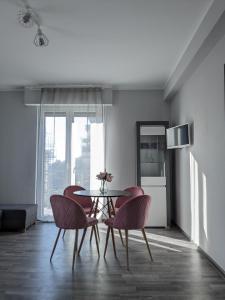 a dining room with a table and two chairs at Bardolino Center Apartments in Bardolino