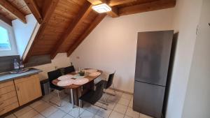 een keuken met een houten tafel en een koelkast bij Ferienwohnung CELI in Rottweil