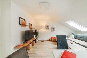 ein Wohnzimmer mit einem Sofa und einem TV in der Unterkunft City Lodge Vienna in Wien