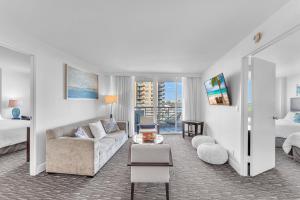 a living room with a couch and a bed at Eternal Sunrise Suite in Fort Lauderdale +26 photos