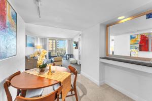a dining room with a table and chairs and a window at Eternal Sunrise Suite in Fort Lauderdale