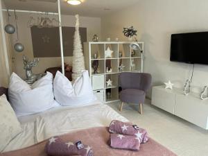 a bedroom with a white bed and a chair at Sonnenblick in Teufenbach