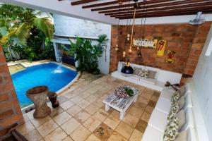 an indoor swimming pool in a house with a patio at Hotel Cauca Viejo Fundadores in Jericó