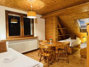 a room with a table and chairs and a bedroom at Hotel Nest in Berlin