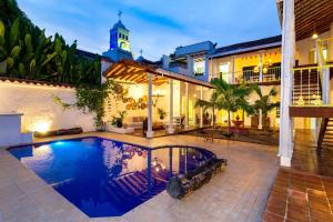 a house with a swimming pool and a clock tower at Hotel Boutique Fundadores en Cauca Viejo in Jericó +190 photos